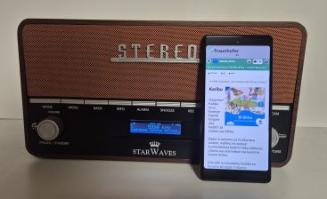 Starwaves DRM radio with a smartphone in front of it, playing the Edutab podcast via the radio’s built-in Wi-Fi hotspot.
